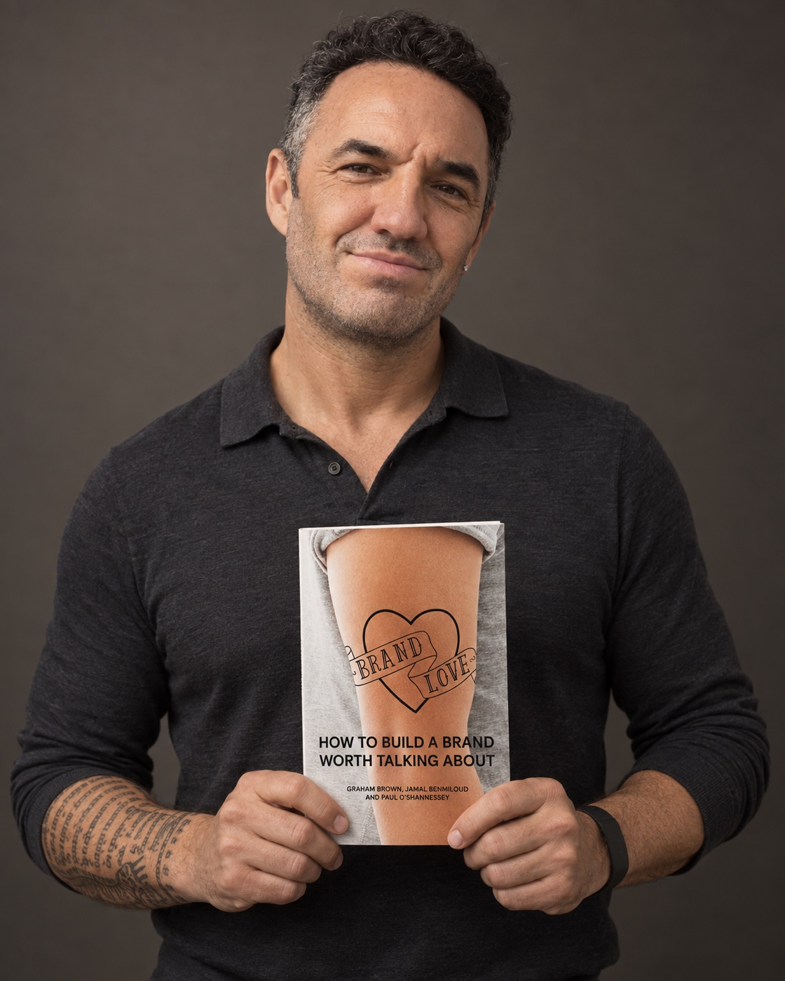Graham Brown holding his book Brand Love
